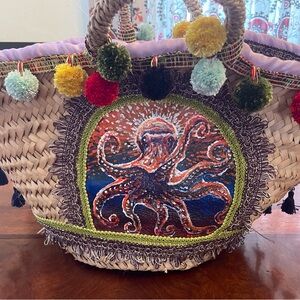 Hand painted leather on sea grass tote. Hand sewn embellishments. One of a kind